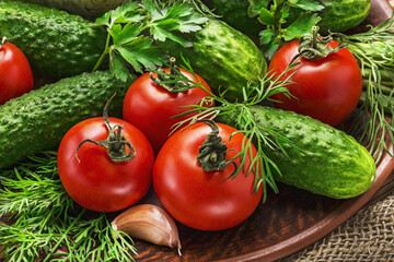 Fresh organic vegetables on a wooden table tomatoes, onions, cucumbers.