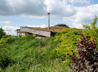 Roof of modern self sufficient earth house with soil against the walls