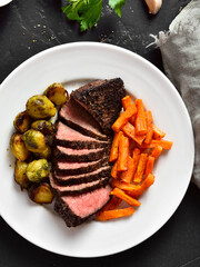 Grilled beef steak with brussels sprouts and sweet potatoes