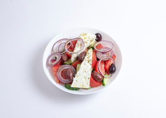 Greek salad with cheese and fresh vegetables isolated on white background. top view