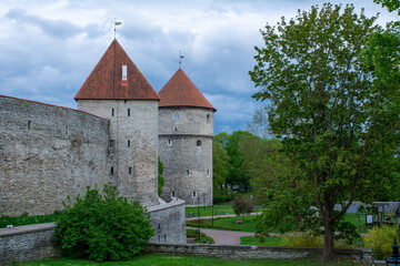 Fototapeta na wymiar Walls and towers of old Tallinn, Estonia against a dramatic sky