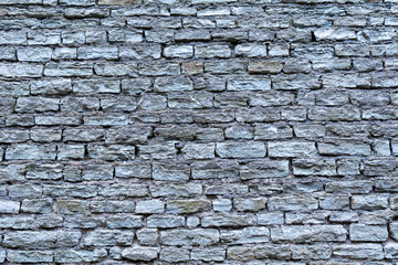 Stonewall background structure. Texture of an old Wall made of rough stondes