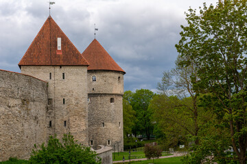 Fototapeta na wymiar Walls and towers of old Tallinn, Estonia against a dramatic sky