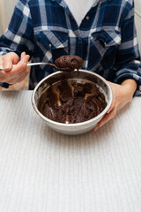 Preparation for baking chocolate brownie, dough in a metal bowl. Cooking cookies at home.