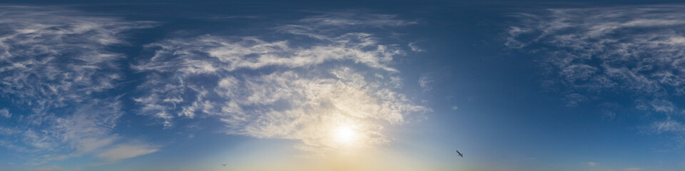 Obraz premium Panorama of a dark blue sunset sky with golden Cumulus clouds. Seamless hdr 360 panorama in spherical equiangular format. Full zenith for 3D visualization, sky replacement for aerial drone panoramas.