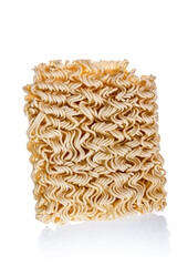 Dry uncooked instant noodles in rectangle shape isolated on white background. Unhealthy fast food or junk food concept.