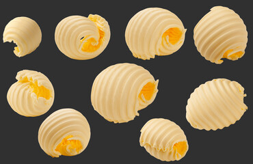 Butter curls rolled up isolated on black background. Set of pieces of butter.