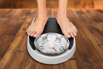 obesity and overweight, overweight woman feet on the scale, obesity and bad habits concept.