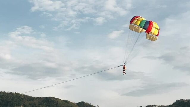 Parasailing over the ocean, slow motion view