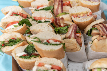 Submarine sandwiches are made and individually wrapped and cut for each member of the birthday party to eat