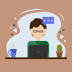 A young man with a laptop is sitting at a table.