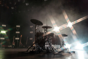Stage lights surrounding a drum set at a concert in Webster Hall, East Village, New York City are...