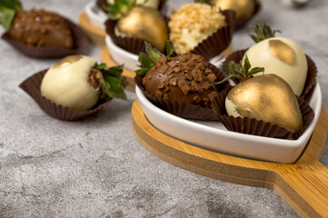 Fresh strawberries covered in white and milk chocolate. Dessert