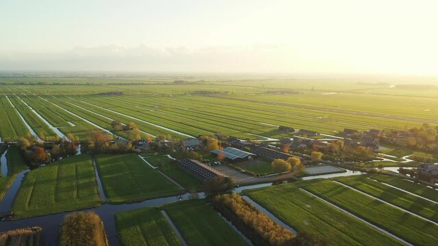 Dutch farmland by sunset in the Autumn. Aerial drone footage, South Holland, the Netherlands.