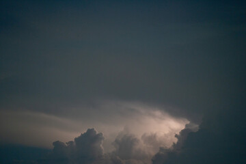 dark clouds and thunderstorm in the Bavarian Forest with bright sheet lightning