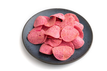 red potato chips with herbs and tomatoes isolated on white background. Side view, close up.
