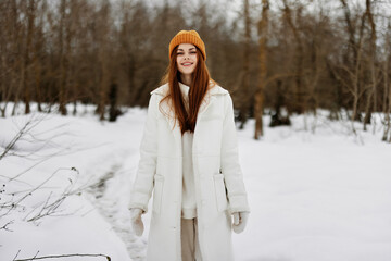 portrait of a woman red hair walk in the fresh winter air Walk in the winter forest
