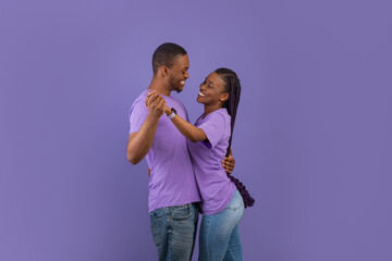 Portrait of romantic black couple dancing at studio