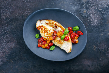 Roasted swordfish steak with tomatoes and paprika served as top view on a design plate - obrazy, fototapety, plakaty