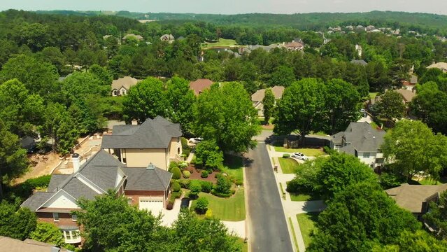 Aerial drone footage shot in 4K of an upscale suburbs with beautiful houses and manicured lawns in suburbs of Atlanta.
