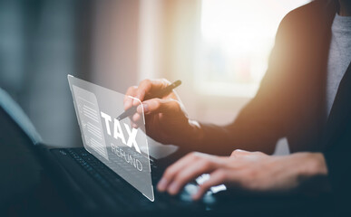 Hand using tablet with bar TAX REFUND and refund tax of duty taxation business, graphs and chart being demonstrated on the screen media, tablet pc and selecting tax refund.
