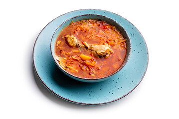 Ukrainian traditional cuisine. Red borscht with chicken in a blue plate. Isolate on white background