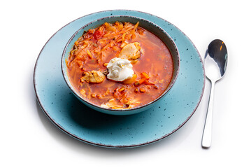 Ukrainian traditional cuisine. Red borscht with chicken in a blue plate. Isolate on white background