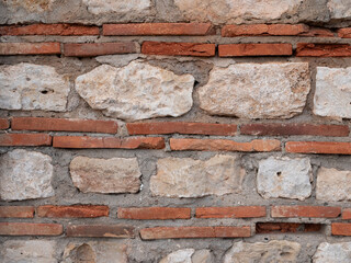 Texture of brickwork and stone masonry. Background of an old wall. Combination of plinths and limestone as as building materials in Byzantine masonry