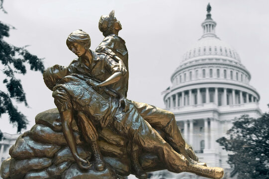 Memorial statues of Vietnam war Women Nurse illustrate over Capitol background 