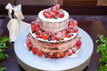Two-tiered original cake with lots of strawberries