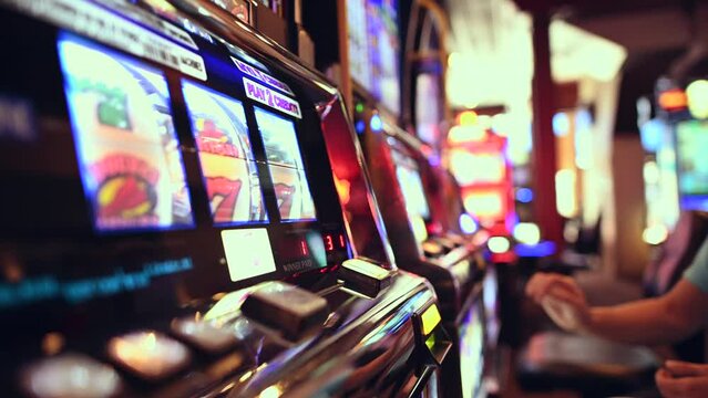 People Playing Casino Slot Machines Close Up