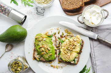 Healthy avocado toasts for breakfast or lunch with rye bread