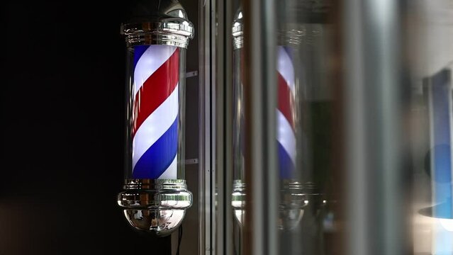 Barber shop vintage pole. copyspace Barbershop. Barber shop pole in red white and blue with lightbulb on top