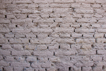 Old gray clay brick wall