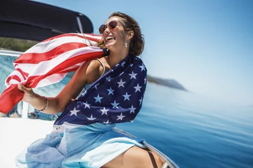 Fotobehang Woman With US National Flag Spending Day On Private Yacht © milanmarkovic78