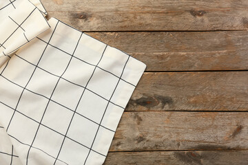 New checkered tablecloth for picnic on wooden background - obrazy, fototapety, plakaty
