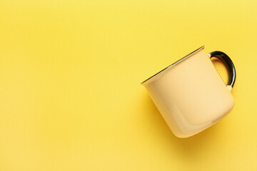 New ceramic cup on yellow background