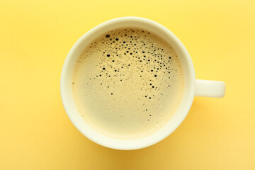 Cup of hot aromatic coffee on color background