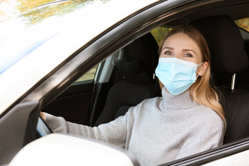Female driver wearing medical mask in car