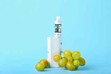 Modern vape mod and grape on blue background