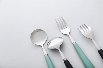 Different stainless steel cutlery on light background, closeup
