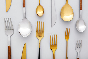 Different stainless steel cutlery on light background, closeup