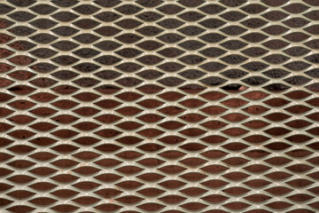 A texture of a decorative metal grille as a background.