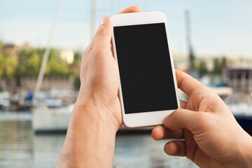 Hands holding smartphone with blank screen