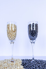 Corn and beans grains inside wine glasses , Global food crisis concept