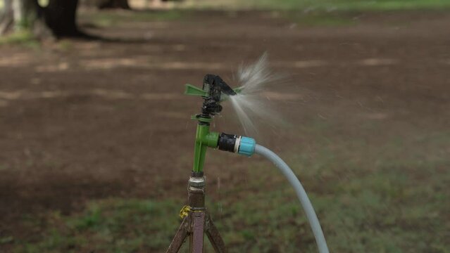 Close-up device for artificial watering of greenery or fields. Artificial irrigation of plants. Device for watering.