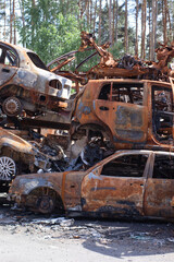 war in ukraine. Car graveyard. Shot cars of civilians. russia's war against Ukraine. Burnt and blown up car. Cars damaged after shelling. irpin bucha. war crimes
