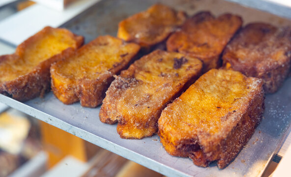 Traditional Easter croutons of Spanish cuisine Torrija, laid out on the counter for sale