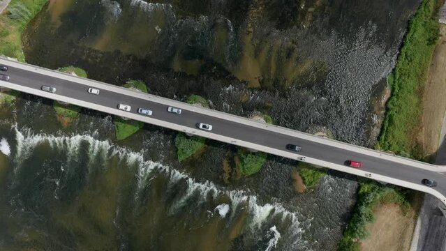 4k Aerial footage on Pont du Marechal Leclerc over Loire river with traffic from drone. Sunny day, waves, river flow,green moss underwater. Amboise bridge. HD footage.