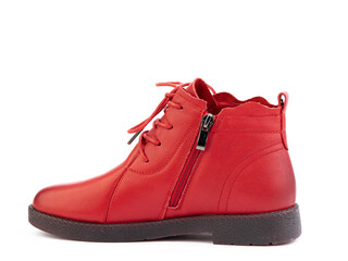 Women's autumn red leather jodhpur boots with black sole isolated on white background. Left side view. Fashion shoes. Photoshoot for shoe shop concept.